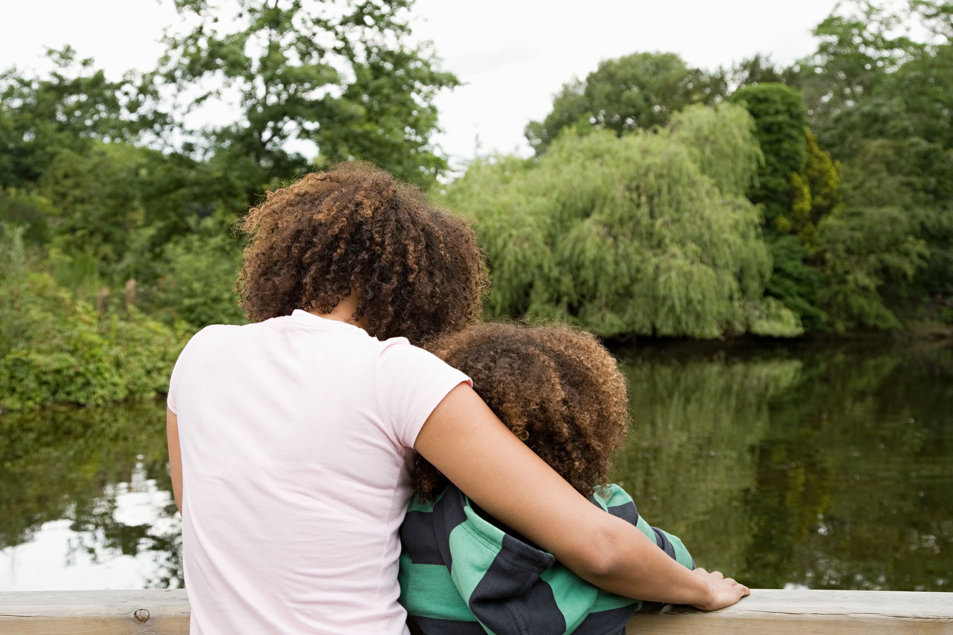 Mother and son looking at lake